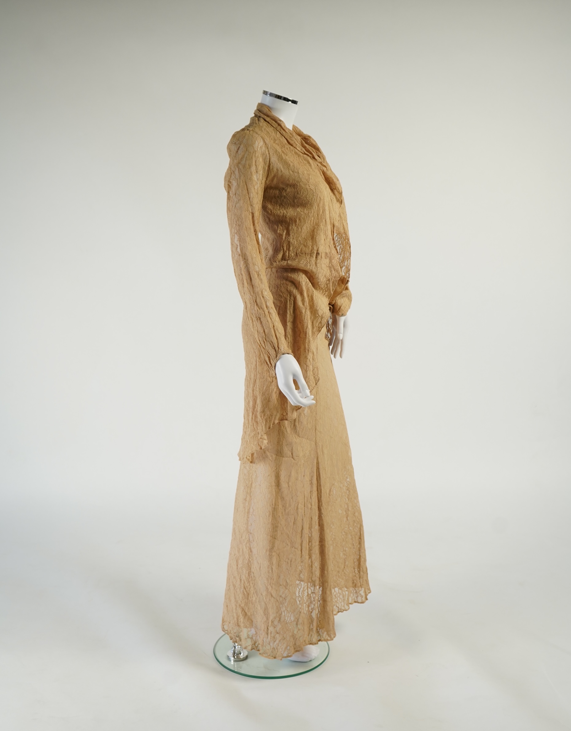A flesh coloured 1930s lace evening dress and matching jacket together with a bottle green velvet evening dress and buckle belt and an unusual green shot silk pleated under skirt. Lace dress bust 32 inches. 156cm long. C